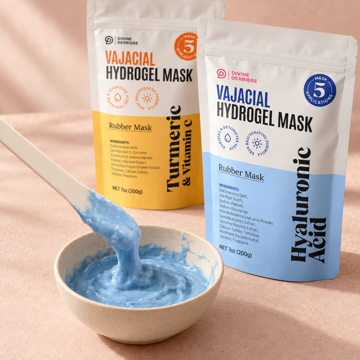 A spatula lifting freshly mixed blue hydrogel mask over an ivory bowl, alongside Divine Derriere Turmeric and Hyaluronic Acid vajacial pouches